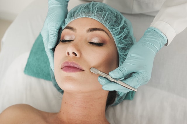 Medical provider applying facial treatment to female client